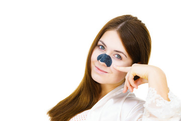Woman applying pore strips on nose