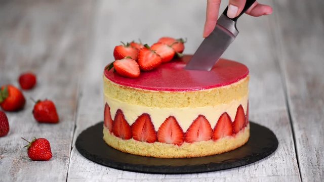 Strawberry cake. Fraisier cake on wooden background