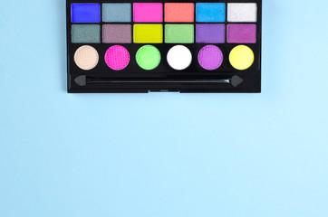Neon palette of shadows on a blue background.