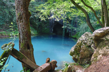 Amazingly beautiful mountain's spring with heavenly blue water color and small waterfall named Krupajsko Vrelo (spring of Krupaj), near Krupaja village, Eastern Serbia 