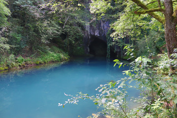 Amazingly beautiful mountain's spring with heavenly blue water color and small waterfall named Krupajsko Vrelo (spring of Krupaj), near Krupaja village, Eastern Serbia 