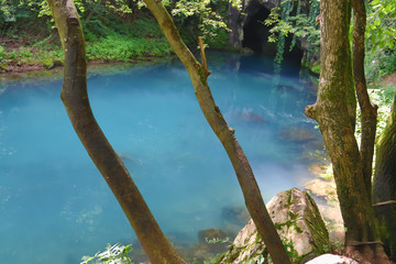 Amazingly beautiful mountain's spring with heavenly blue water color and small waterfall named Krupajsko Vrelo (spring of Krupaj), near Krupaja village, Eastern Serbia 