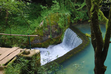 Amazingly beautiful mountain's spring with heavenly blue water color and small waterfall named Krupajsko Vrelo (spring of Krupaj), near Krupaja village, Eastern Serbia 