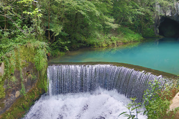 Amazingly beautiful mountain's spring with heavenly blue water color and small waterfall named Krupajsko Vrelo (spring of Krupaj), near Krupaja village, Eastern Serbia 