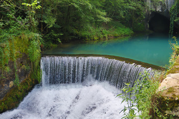 Amazingly beautiful mountain's spring with heavenly blue water color and small waterfall named Krupajsko Vrelo (spring of Krupaj), near Krupaja village, Eastern Serbia 