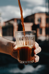 man filling the glass with coffee