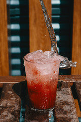 pouring lemonade into a glass