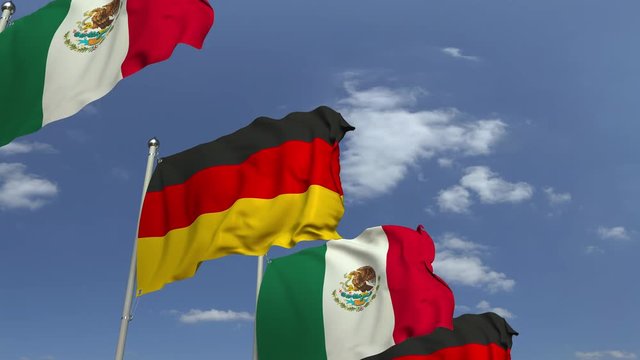 Waving flags of Mexico and Germany on sky background, loopable 3D animation