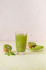 Cocktail with kiwi and mint in a glass on a white background. Selective focus.