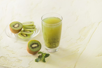 Cocktail with kiwi and mint in a glass on a white background. Selective focus.