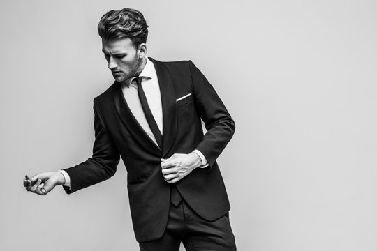 Portrait of young and handsome model in a classic black and white style clothing. Studio shot. Copy space.