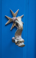 Old door dolphin handle with maltese cross on the azure door, Valletta, Malta