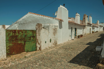 Houses with iron garage gate on street of Evoramonte