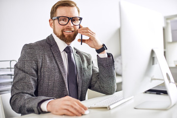 Mid age businessman working on computer at the office