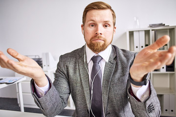 Mid age businessman talking on video call at the office