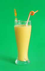 Mango milkshake on green background