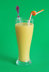 Mango milkshake on green background