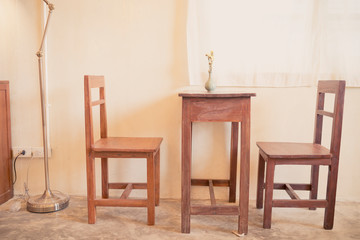 vase on wooden table and chairs furniture in cafe