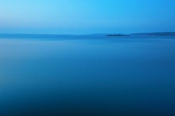 Water landscape with small island in the distance