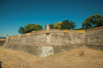 Fototapeta na wymiar Stone city wall corner with watchtower and dry moat