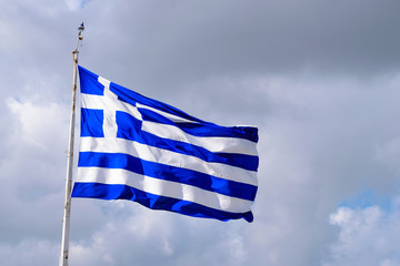 Greek flag with dark cloud background