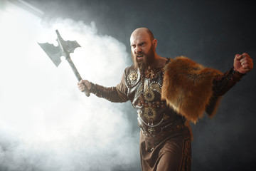 Angry viking with axe, martial spirit, barbarian