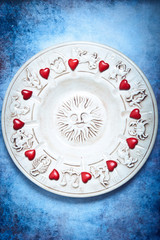 astrology and love concept with zodiac signs, sun and red hearts
