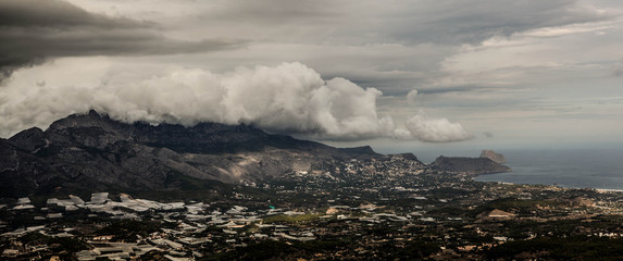 Mountain range covered with thunderstorm clouds, wide panoramic view, Spain, Benidorm.
