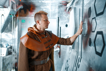 Space scientist holds wires at the control panel
