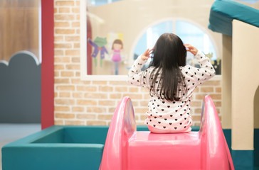 Asian child cute or kid girl playing colorful slider and happy fun or cheerful enjoy on holiday...