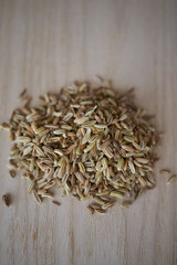 Fennel seeds on a wood tray
