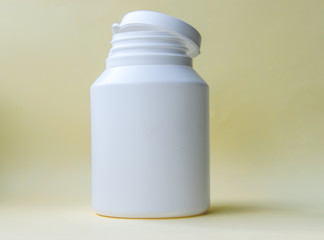 White bottle on a yellow background.