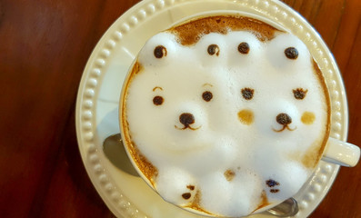 Hot cappuccino coffee in the cup on wood table. Cappuccino mixed with espresso coffee, milk is a fine foam and milk pressurized steam. Sometime garnished with cinnamon powder or cocoa powder on coffee