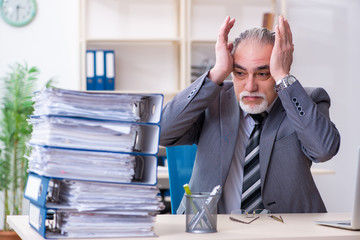Aged male employee unhappy with excessive work 