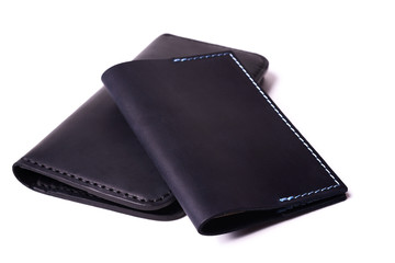 Black handmade leather man wallet and passport cover isolated on white background. Purse and cover are closed. Stock photo of luxury businessman accessories.