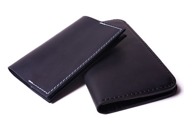 Black handmade leather man wallet and passport cover isolated on white background. Purse and cover are closed. Stock photo of luxury businessman accessories.