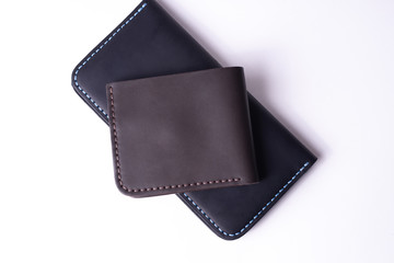 Handmade leather black purse and brown wallet isolated on white background. Stock photo of luxury accessories.