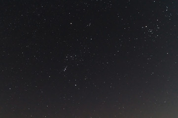 Fototapeta na wymiar Underexposed night sky low light photo. A lot of stars and constellations on dark sky. Stock photo of deep sky.