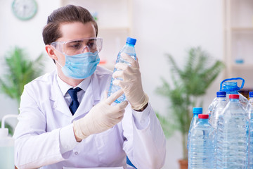 Young male chemist experimenting in lab