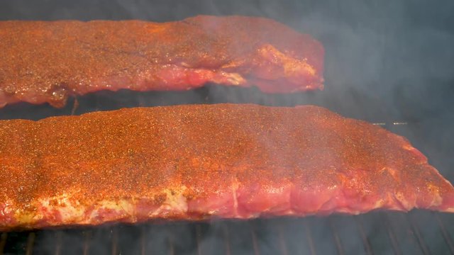 Smoking ribs on the backyard grill - sliding view