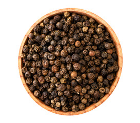 Pepper peas in a wooden plate on a white. The view of the top.