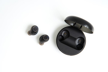 Obraz na płótnie Canvas Black true wireless earbuds with power bank case on the white isolated background