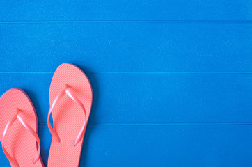Flip flops on blue wooden background. Summer concept. Flat lay, top view, copy space