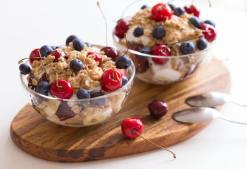 Food. Fruit salad with cherries, blueberry, muesli, yogurt