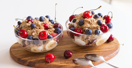 Food. Fruit salad with cherries, blueberry, muesli, yogurt