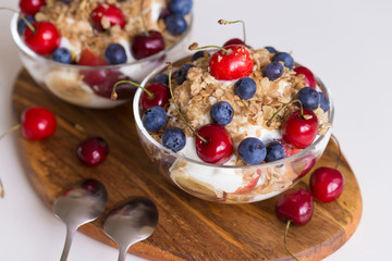 Food. Fruit salad with cherries, blueberry, muesli, yogurt