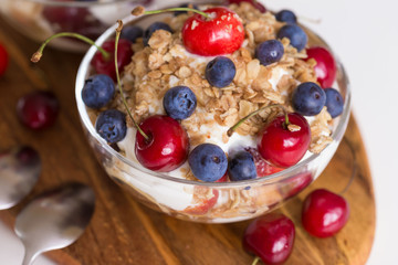 Food. Fruit salad with cherries, blueberry, muesli, yogurt