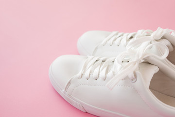 Perfect white New sneakers standing on a bright pink background.