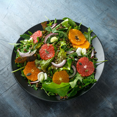 Orange and grapefruit Citrus salad with lentills vertes, wild rocket, arugula, red onion and sprinkle of pumpkin seeds