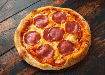 Pepperoni, Salami Pizza on wooden table. ready to eat